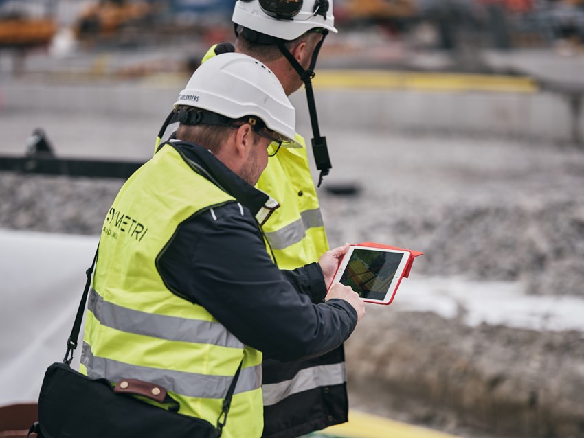 Construction, Symetri man checking BIM model on tablet